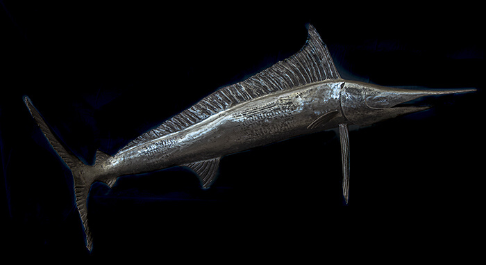Forged iron marlin with a tall ridged dorsal fin running the length of its polished steel back.